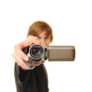 Young adult holding camcorder