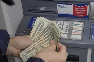 Female cash money fro USbank's atm cash machine